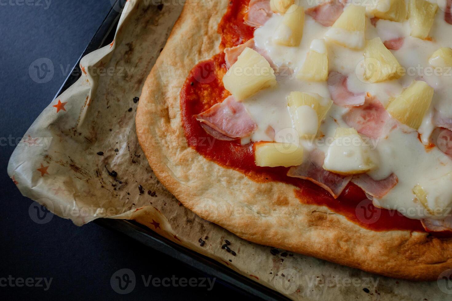 a pizza with pineapple and ham on it photo