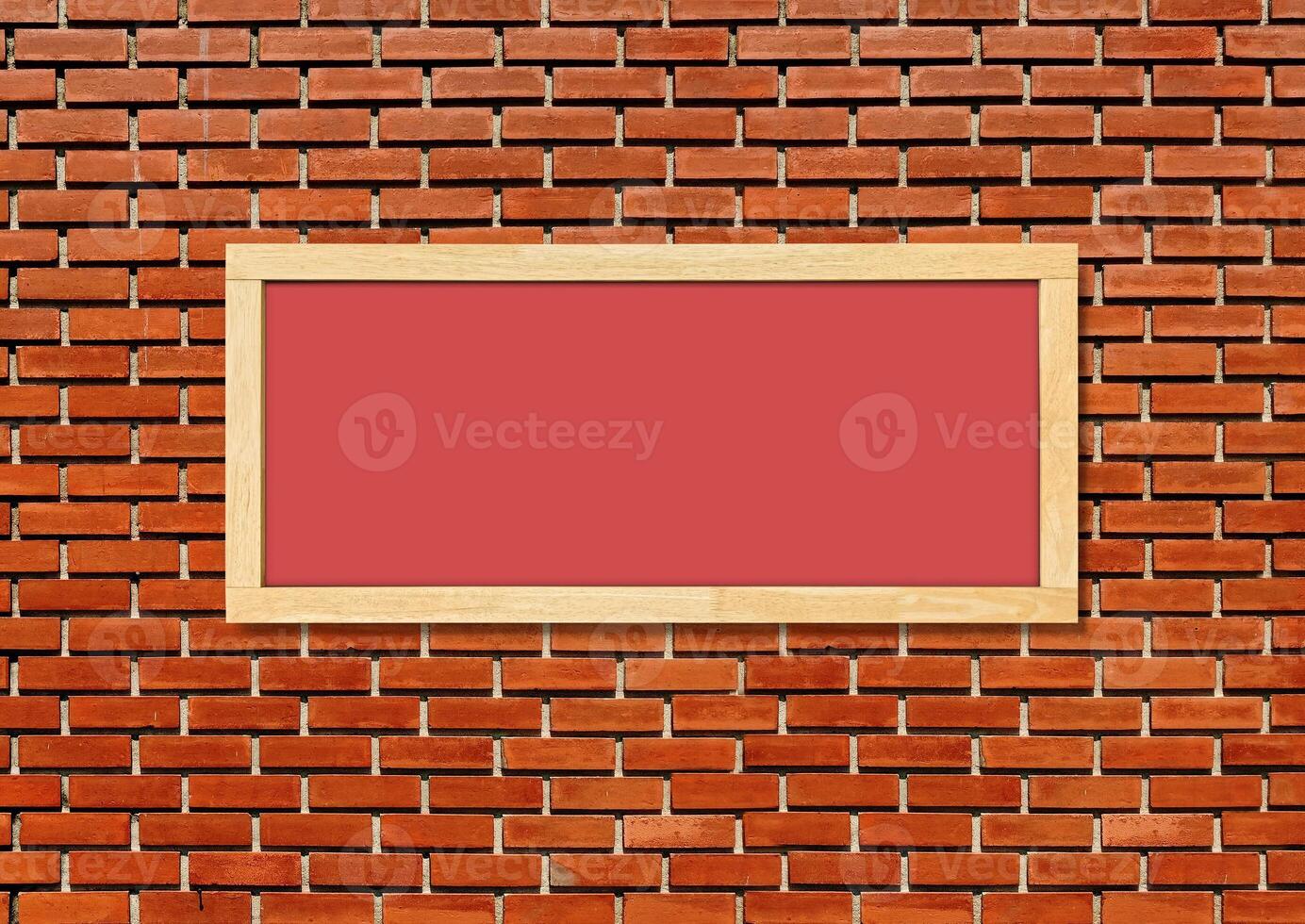 Blank red chalkboard isolated on red brick wall background. photo