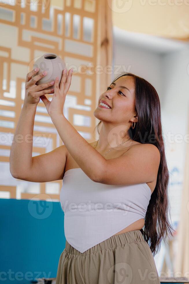 A woman holding a vase in her hand photo