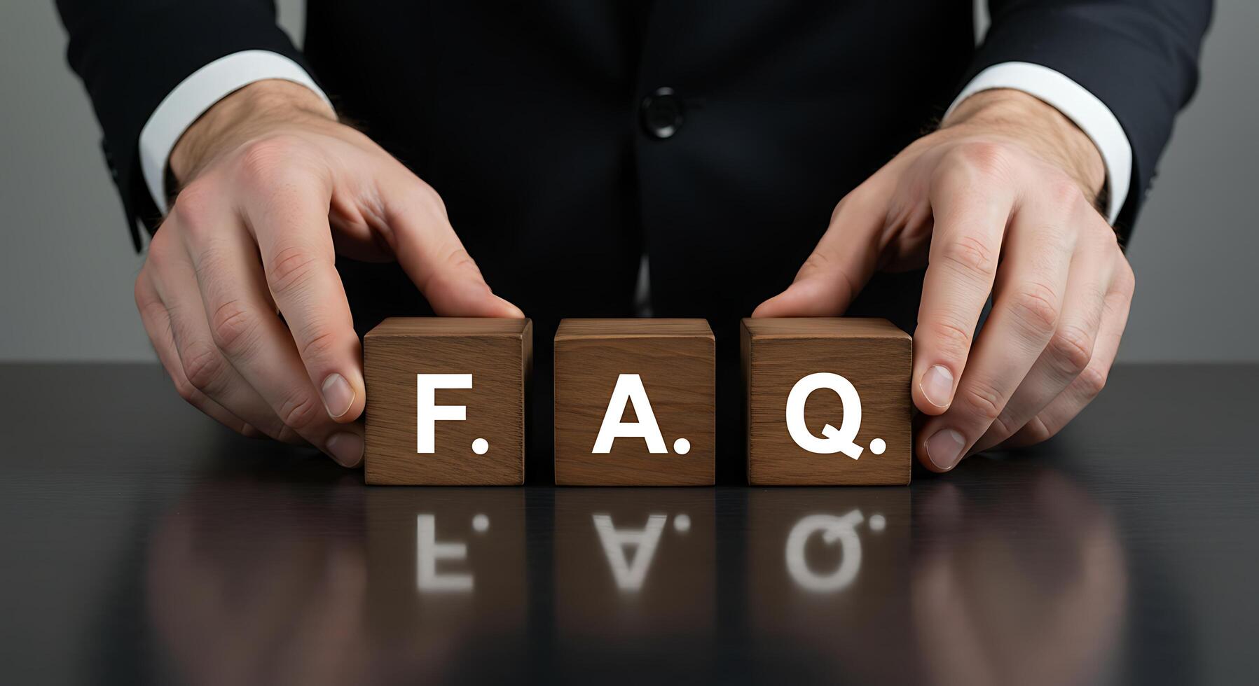 Businessman Arranging FAQ Wooden Blocks on Dark Reflective Surfa photo