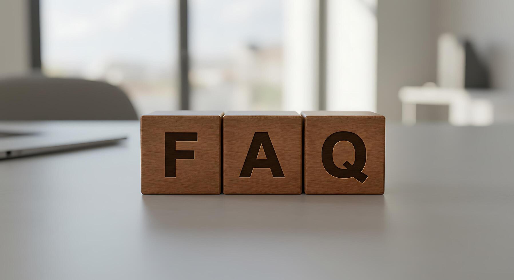 Wooden FAQ Blocks on a White Tabletop with Blurred Background photo