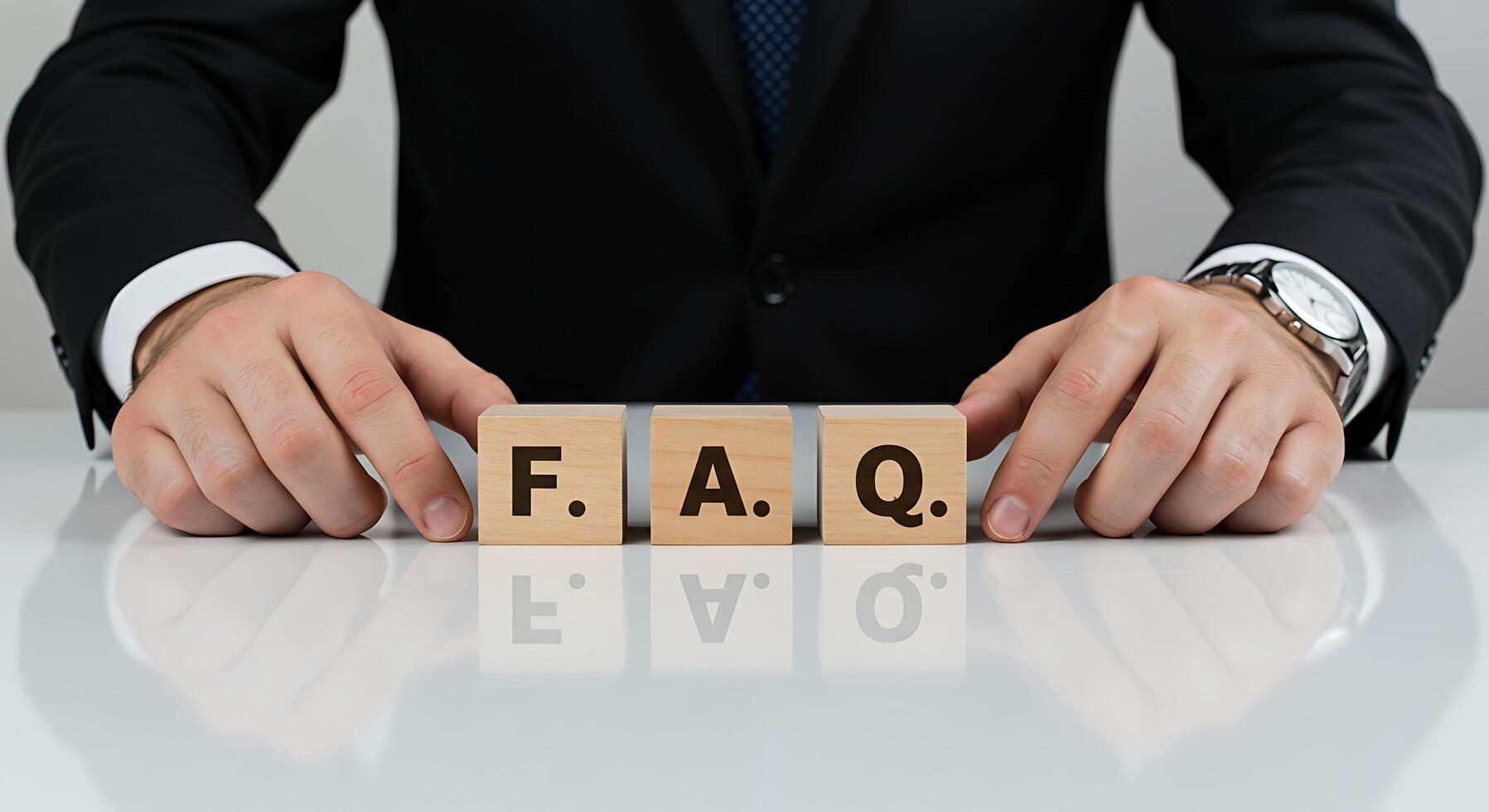 Businessman with FAQ Blocks on Reflective White Table photo