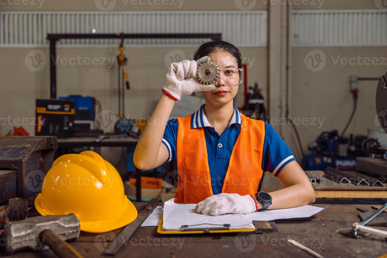 Portrait Chift officer professional Young Woman Engineer Handling gear part in Manufacturing Plant photo