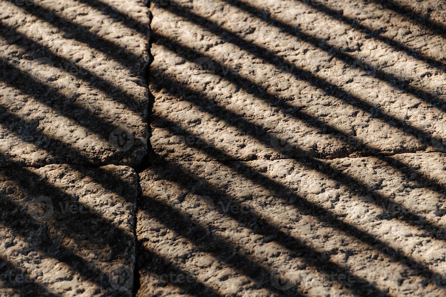 A close up of a stone floor with shadows photo