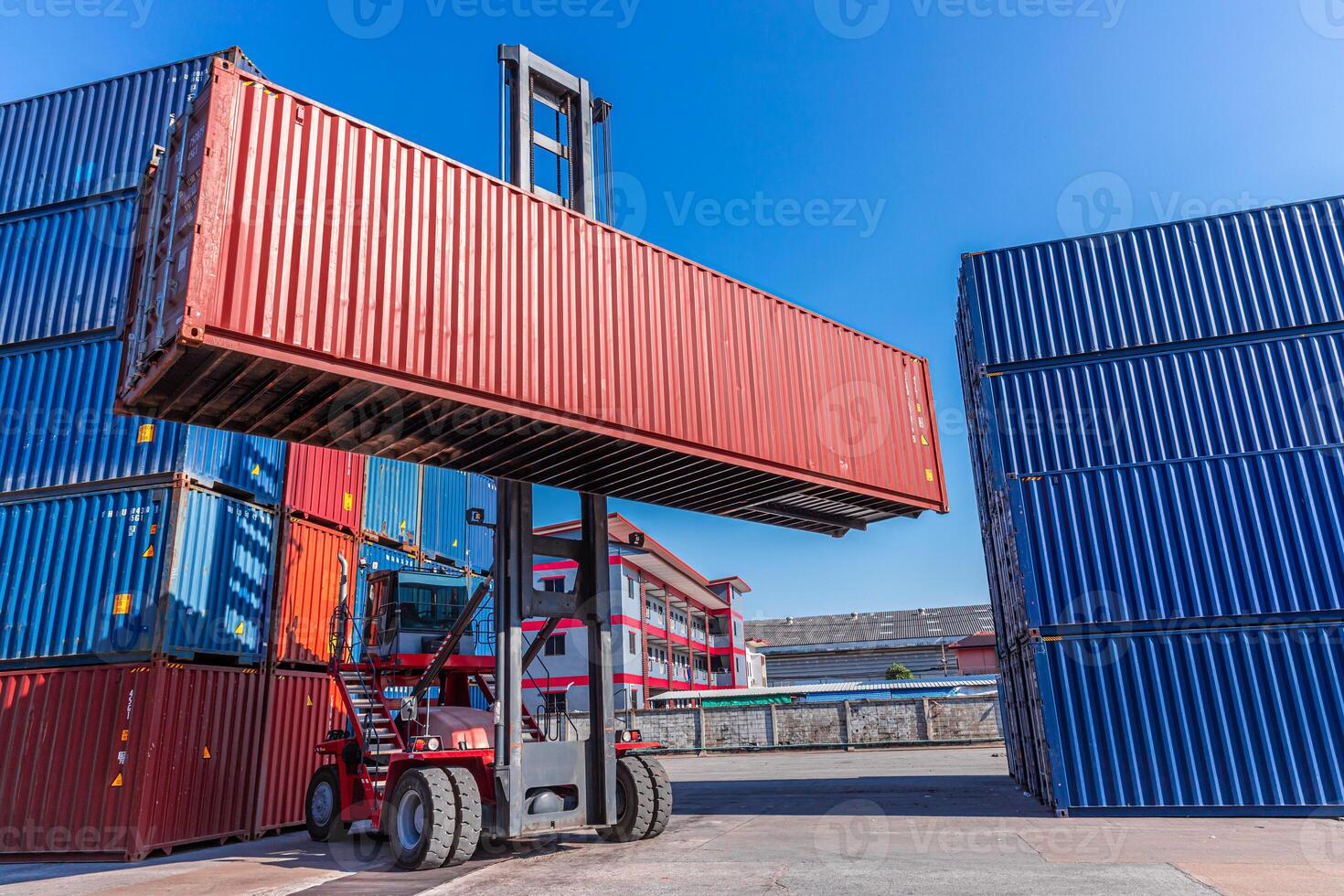 Truck forklift lifting loading heavy container cargo box at port container yard shipping logistics photo