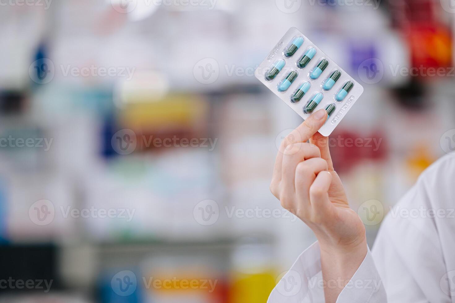 Pharmacist Holding Capsule Medicine Pack With Copy Space For Drug Detail Advertising Text In Pharmacy Drugstore. photo