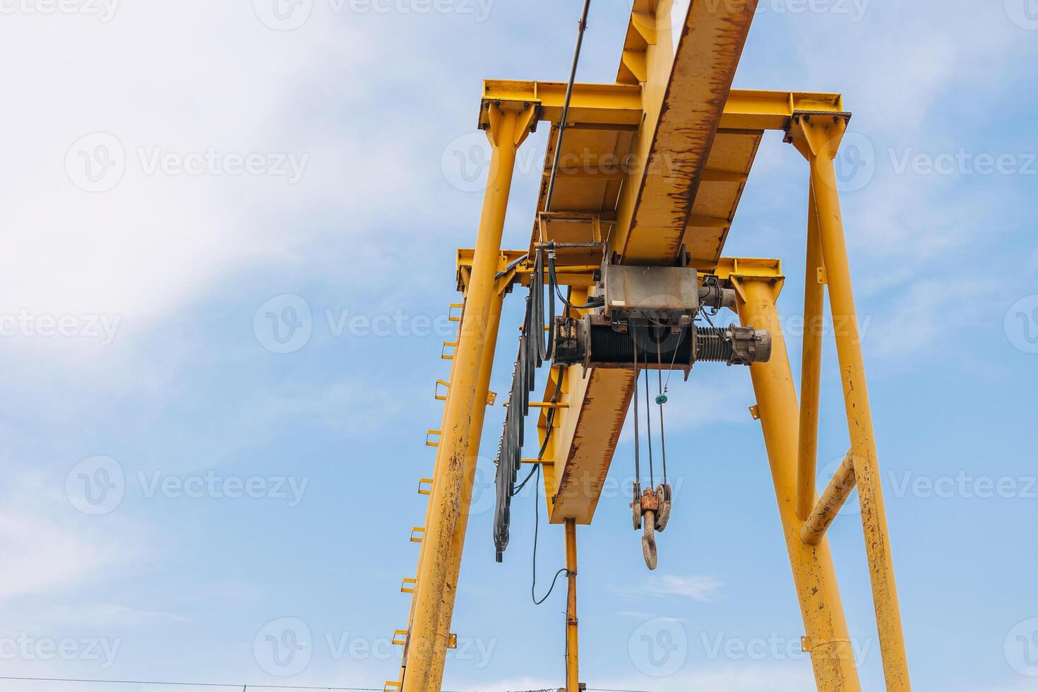 Overhead Crane beam machine with hoist hook head for lifting heavy duty, Construction machine arm in the sky. photo