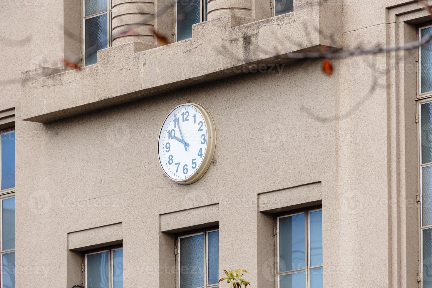 high school facade building with clock at the center in japan traditional style visible in cartoon photo