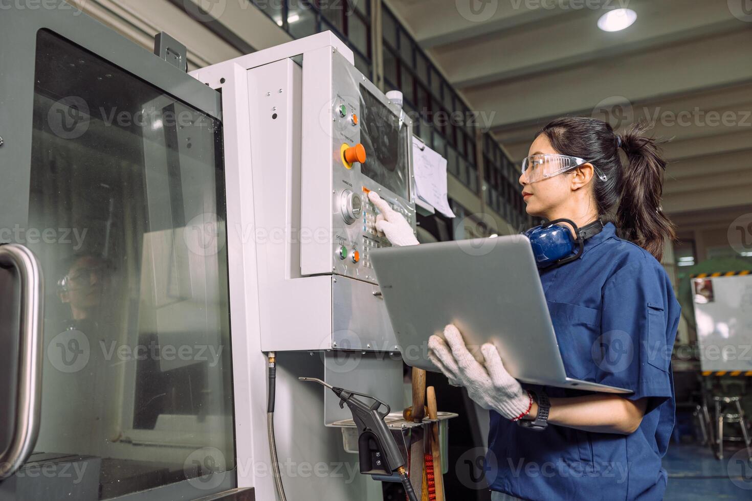 Female Technician Working with Precision on Lathe Machine in Industrial Setting photo