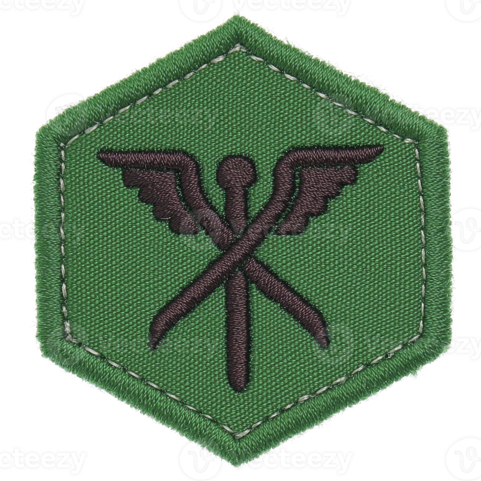 This shows green hexagonal patch with design featuring crossed tools and wings, symbolizing mechanics or engineering. patch has stitched border, giving it rugged appearance png
