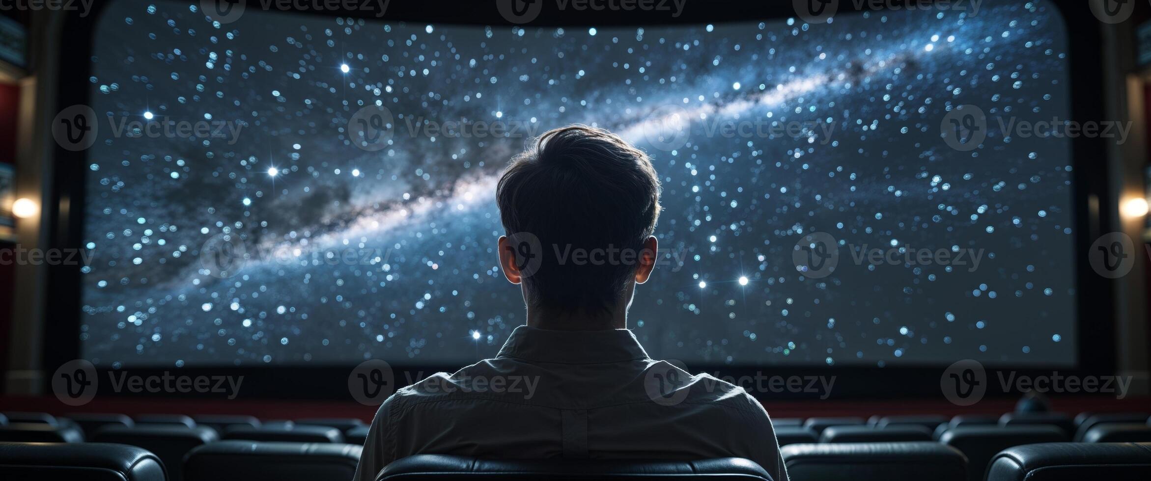 Man Watching Movie in Dark Theater with Starry Screen photo