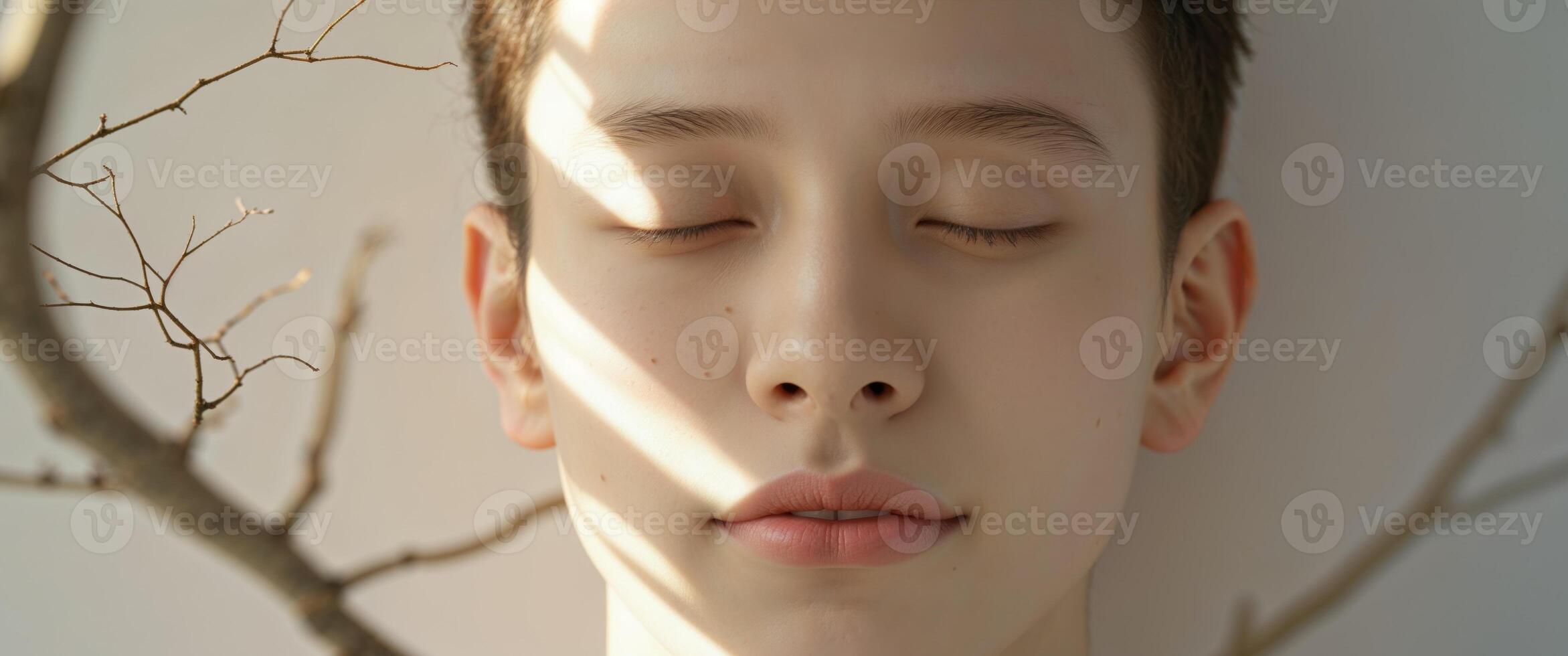 A tight shot of a face with a tree branch superimposed above it photo