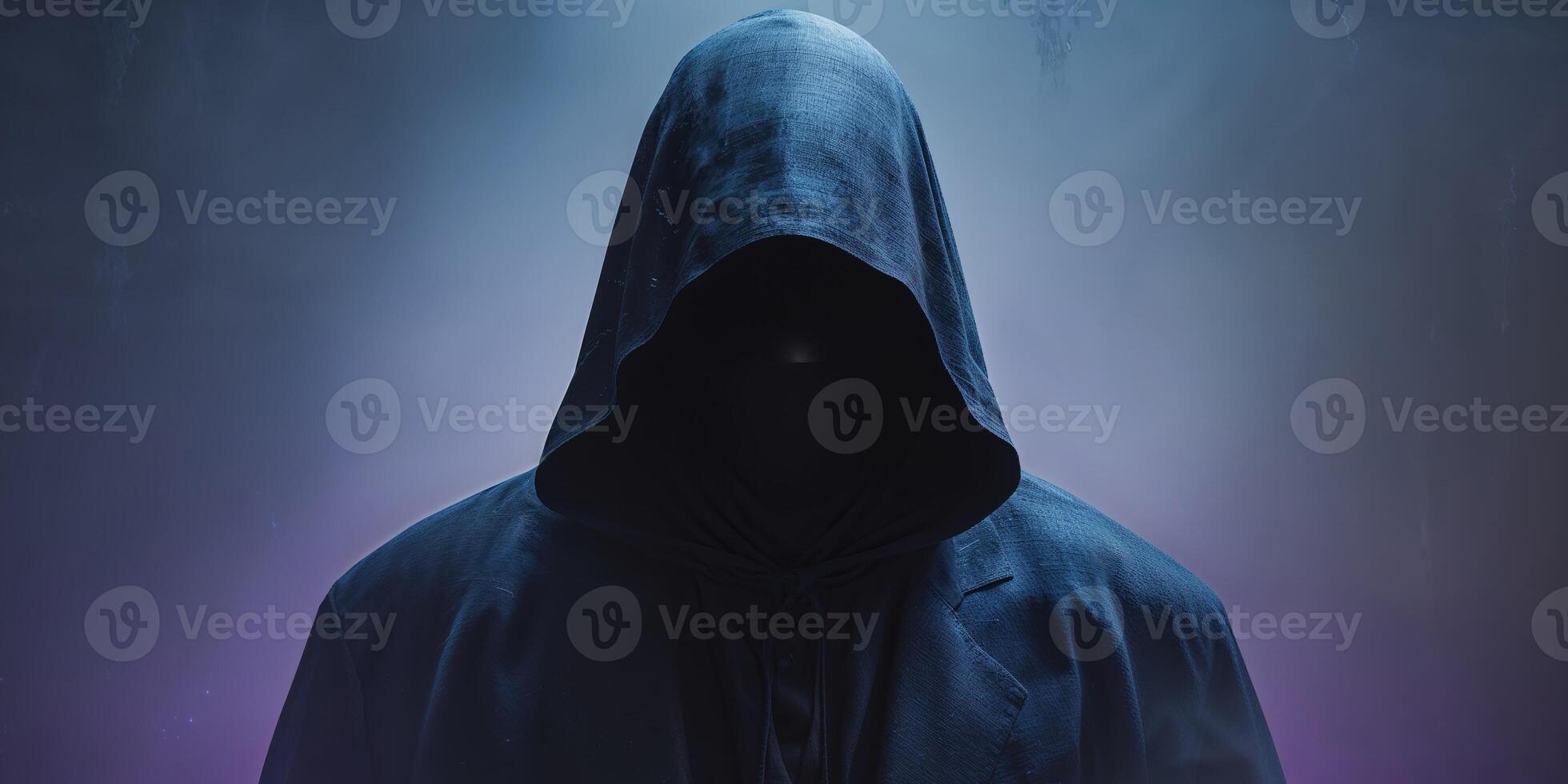 A person in a hoodie standing in front of a dark background photo