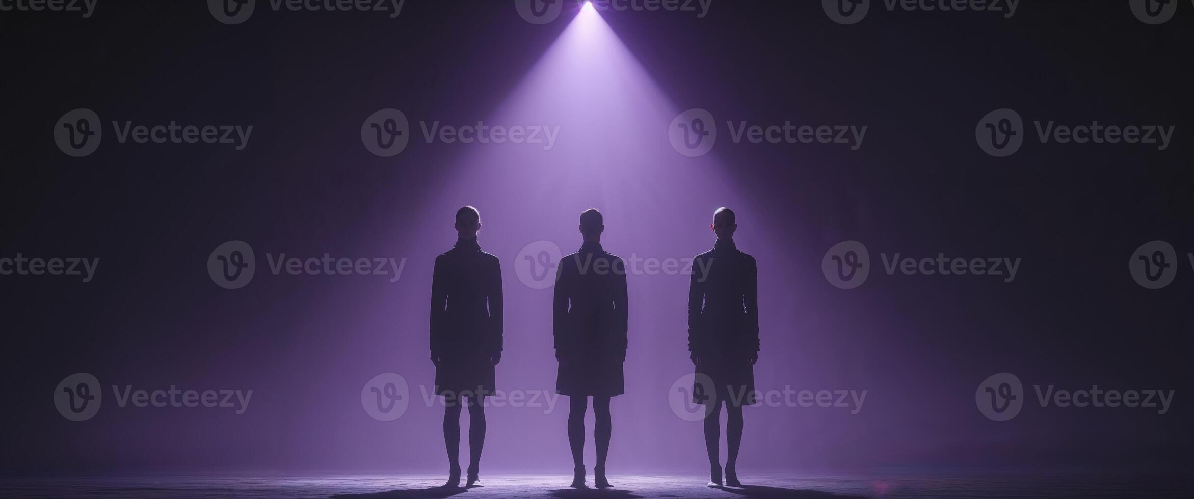 Three people standing in front of a spotlight photo