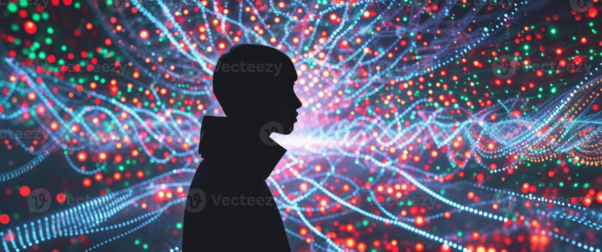 A man standing in front of a colorful light display photo