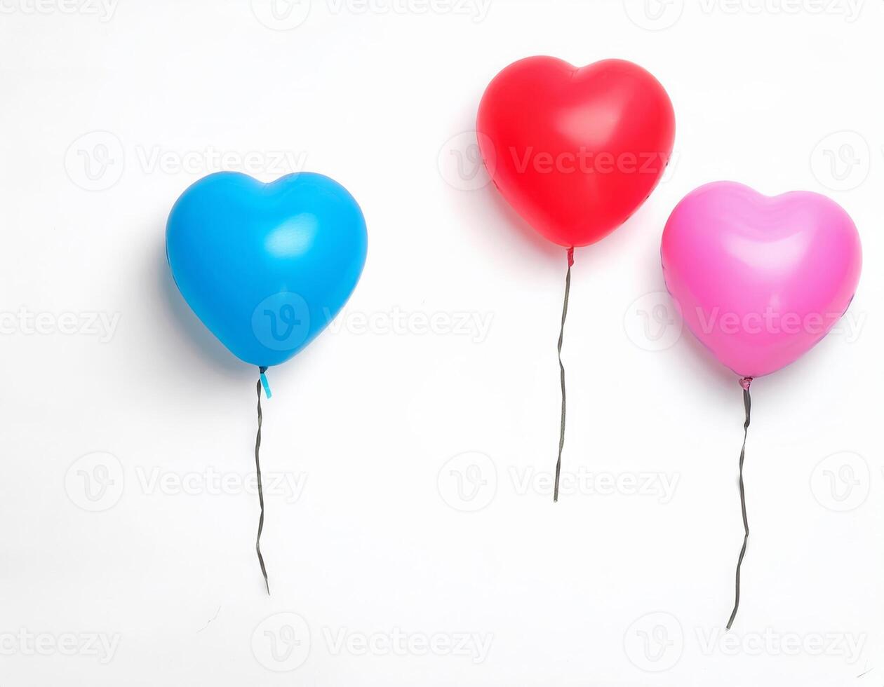 Three Heart Shaped Balloons Floating Against a White Background Red Pink and Blue photo