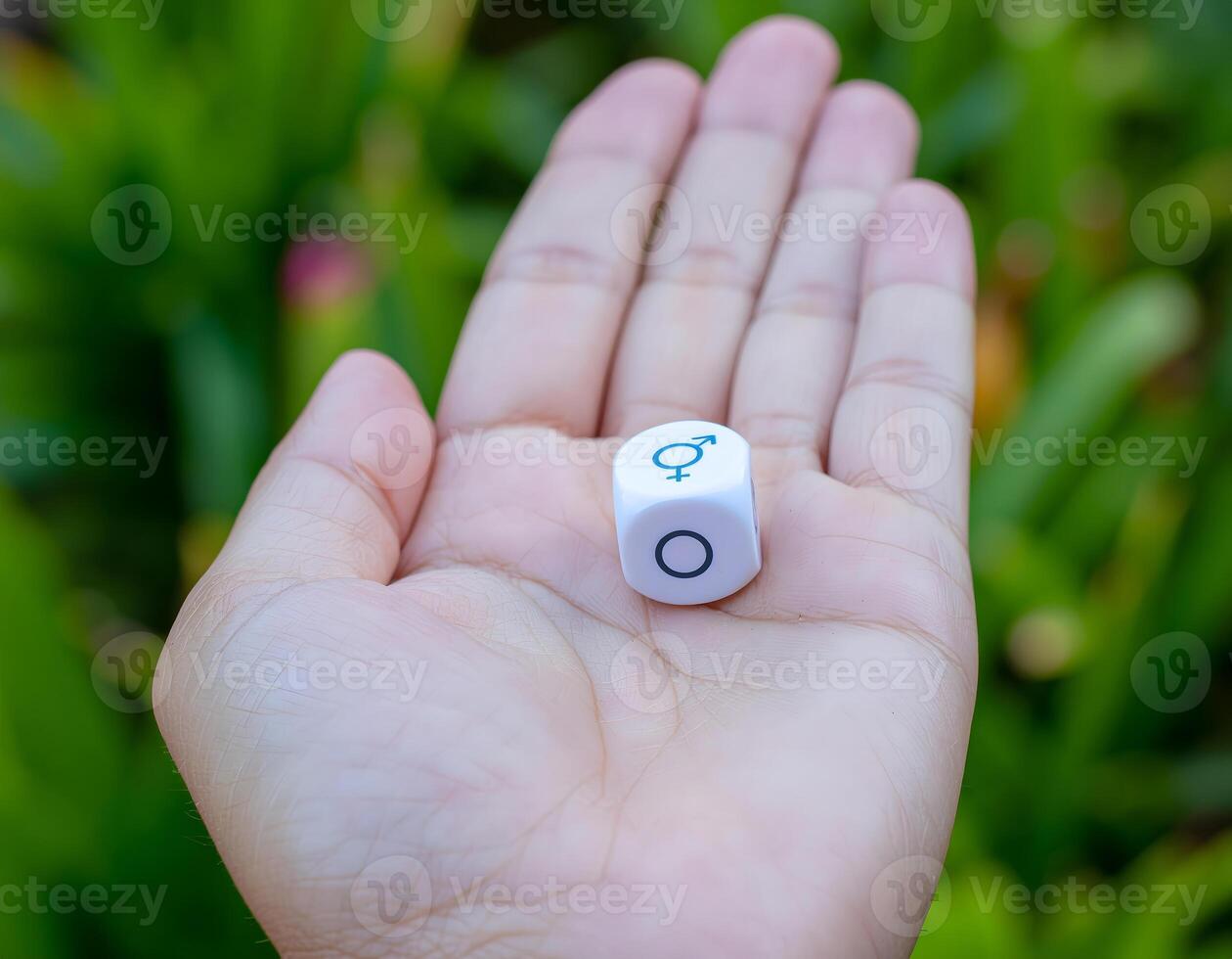 A person holding a dice with a number on it photo
