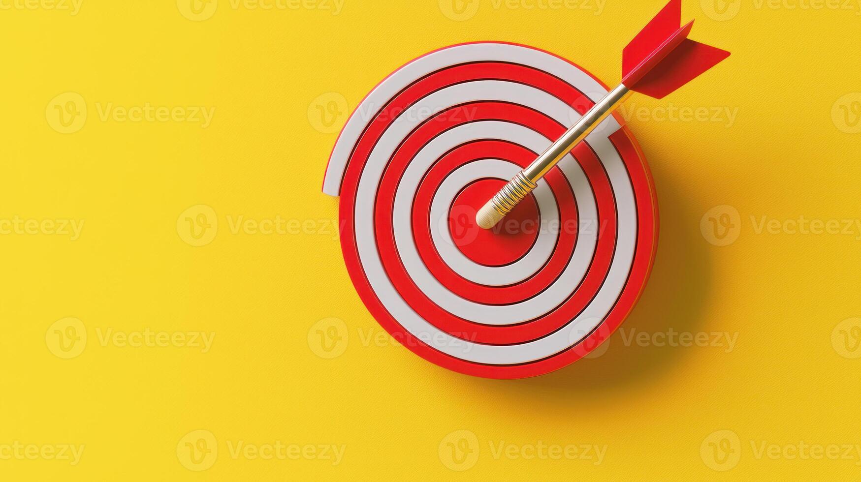 A red dart with a yellow tip is stuck in the center of a red dartboard with a white background. photo