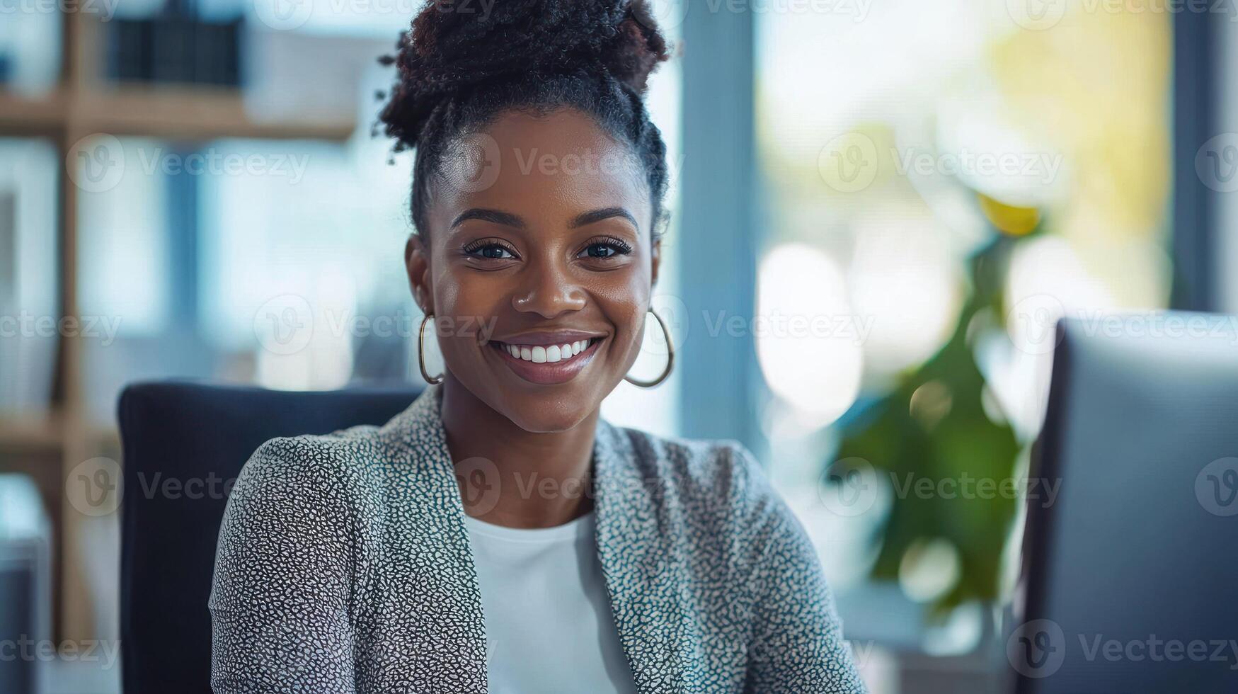 A smiling businesswoman with a confident expression, seated at a desk in a modern office environment. photo