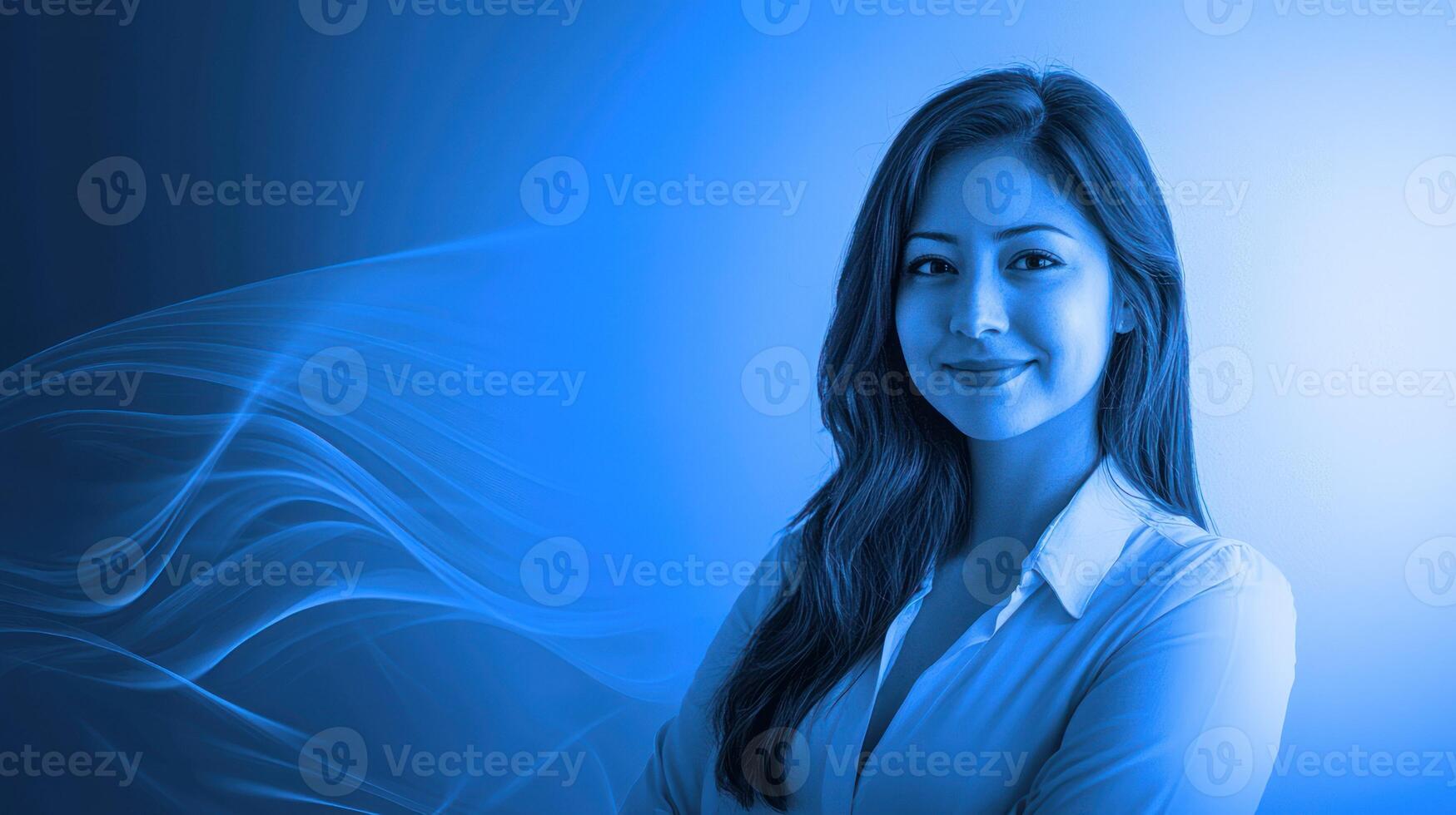 A smiling woman with long dark hair, wearing a white shirt, standing against a blue background with a wave-like pattern. photo