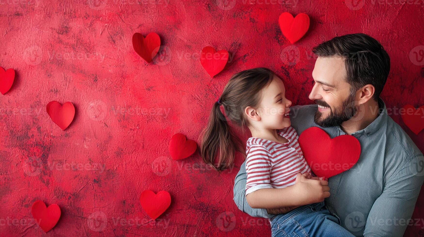 A man and a child hugging each other in front of a red heart-patterned background. photo