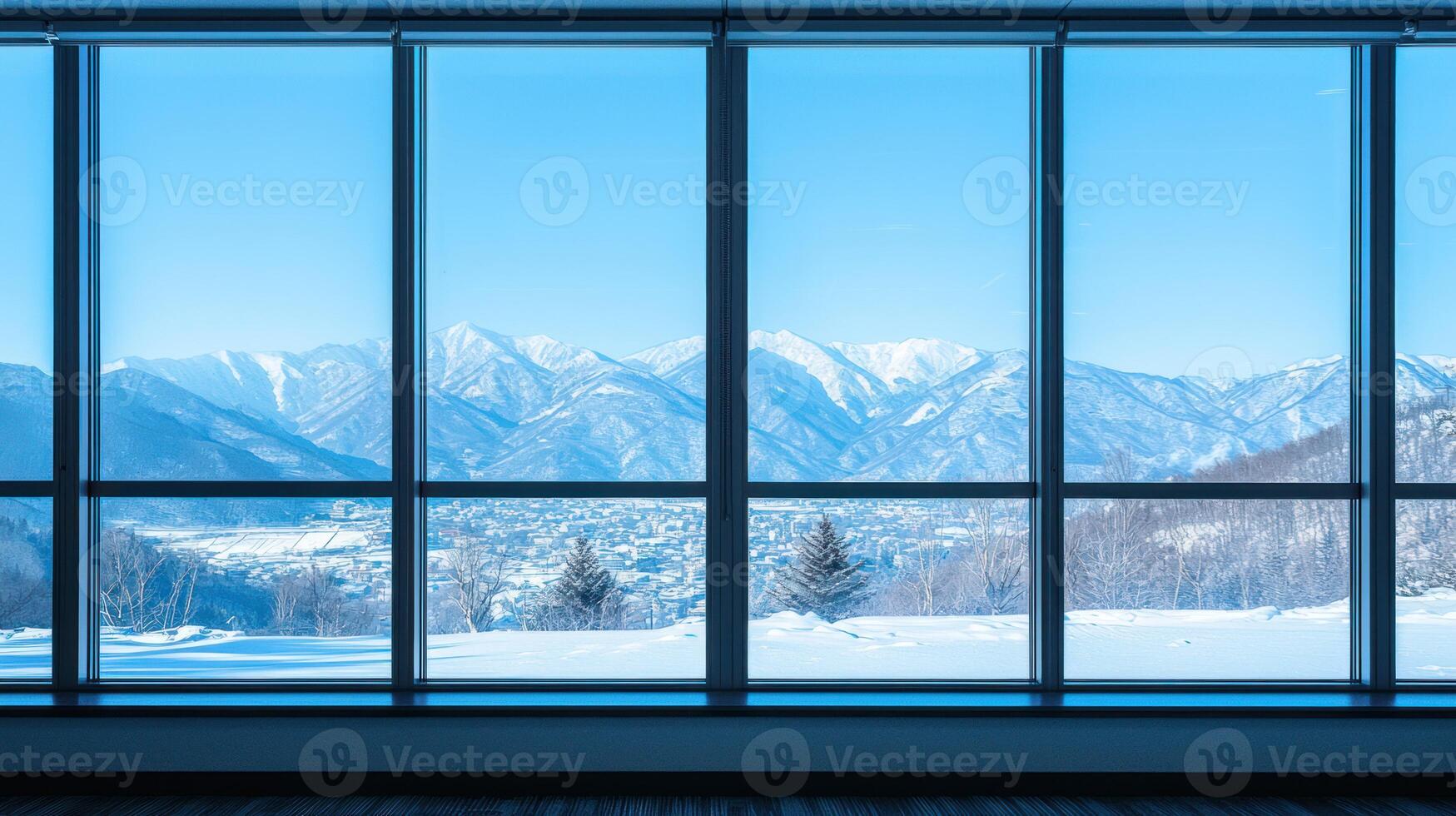 A spacious, modern office with a large window overlooking a snowy mountain range. photo