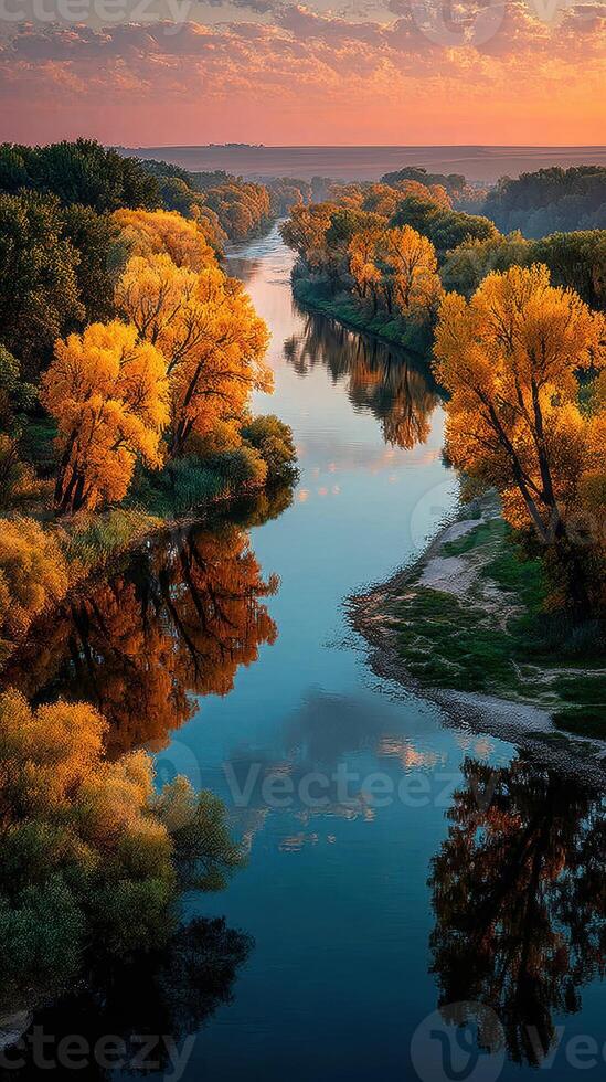 Colorful autumn trees reflect in a calm river during sunset in a tranquil landscape photo