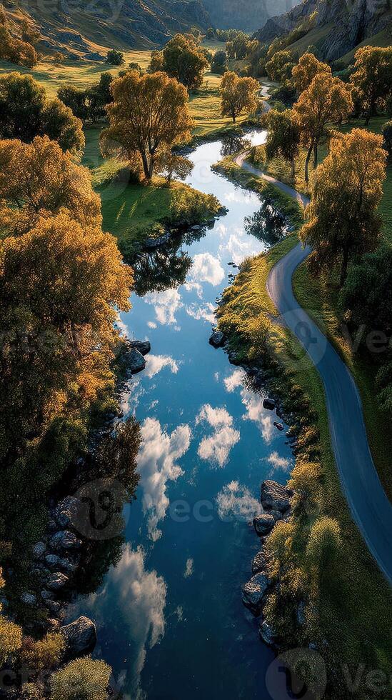 Serene river flowing through a picturesque valley during golden hour in autumn photo