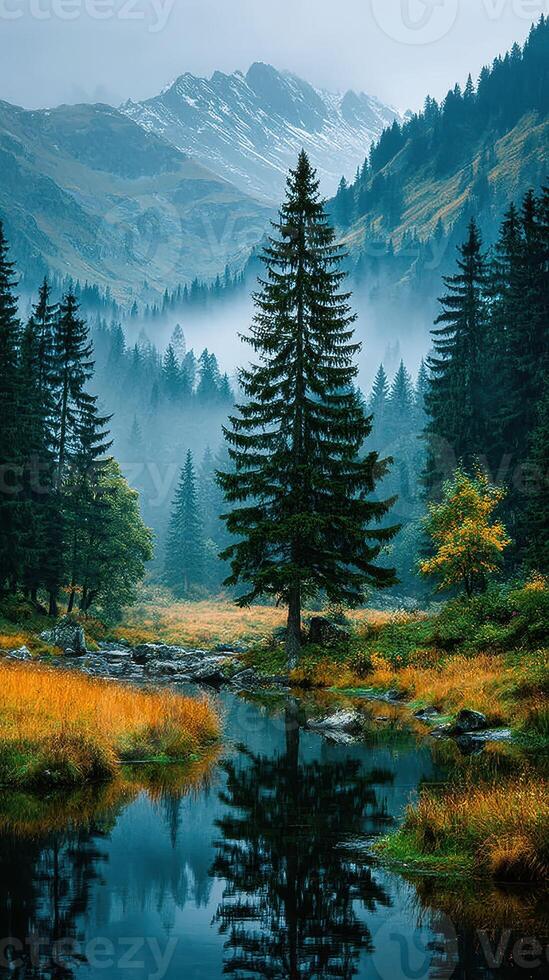 Serene mountain landscape featuring a tranquil lake and towering pine trees in the early morning fog photo
