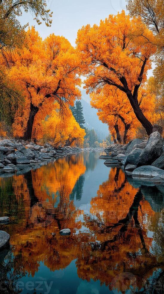 Brilliant autumn colors reflected in a serene river surrounded by golden trees in a tranquil landscape photo