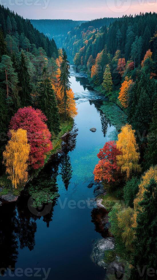 Beautiful autumn landscape with colorful trees reflecting in a serene river at dusk photo