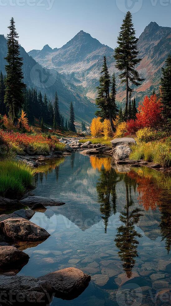 Vibrant autumn landscape with a tranquil stream reflecting mountains in a serene setting photo
