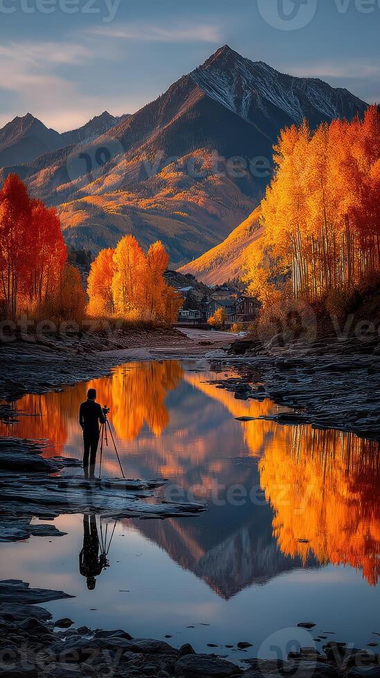 Photographer captures autumn reflections in serene river surrounded by colorful trees in Colorado mountain landscape photo