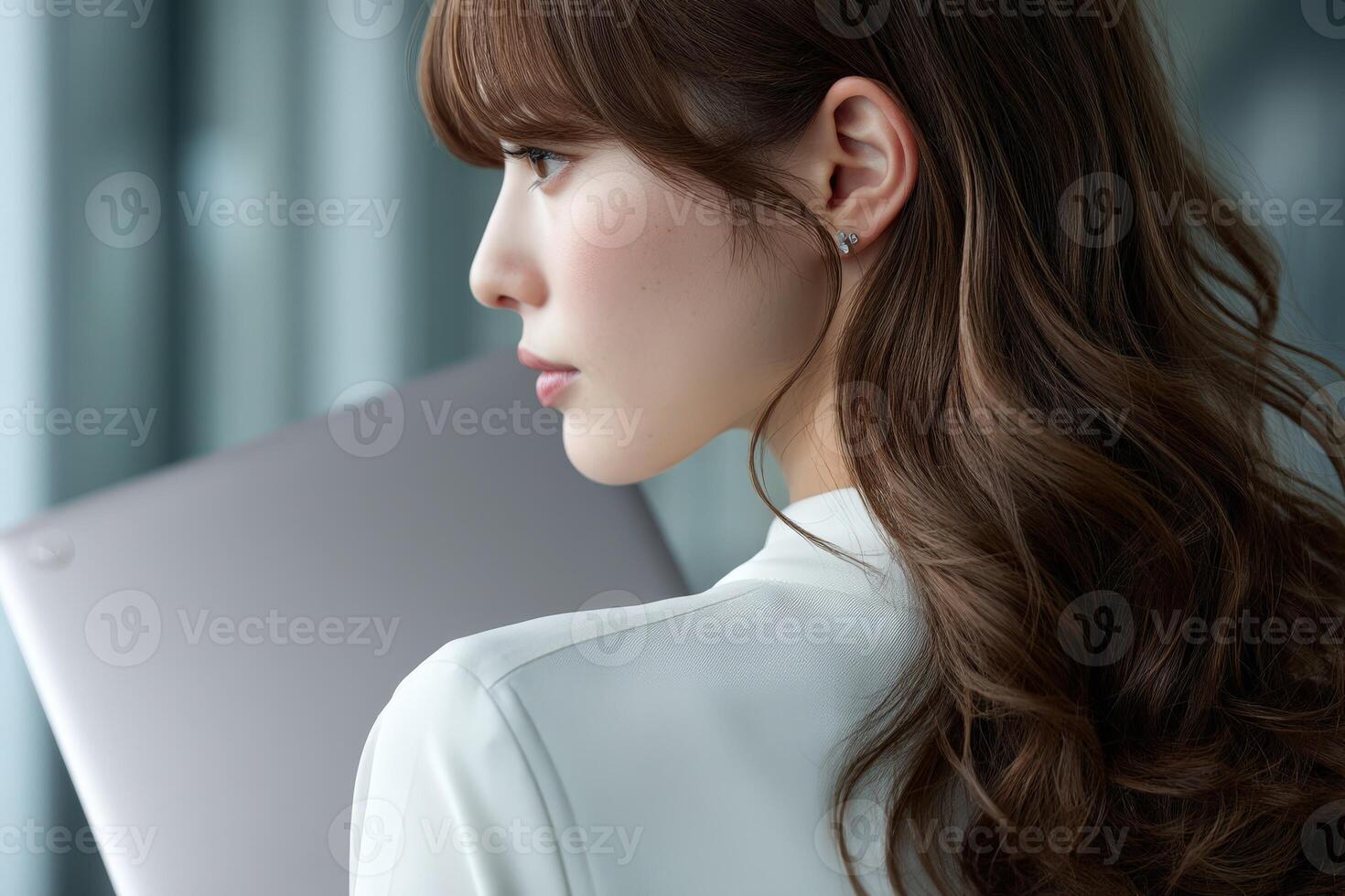 Businesswoman contemplating future while holding a laptop photo