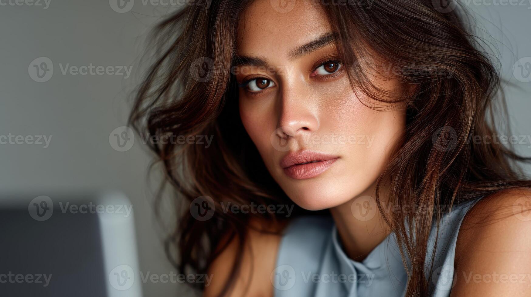 Model poses with soft expression in indoor setting photo