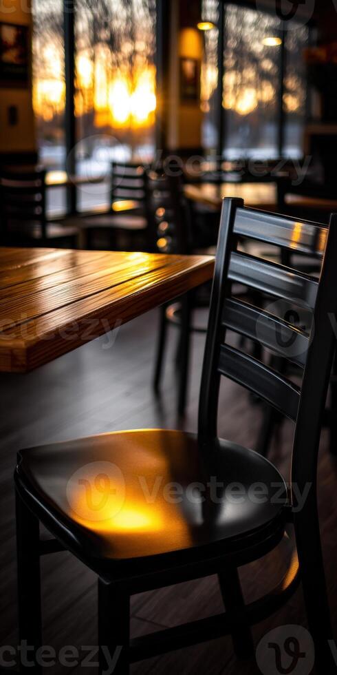 Cozy evening at a cafe with warm light reflecting on furniture photo