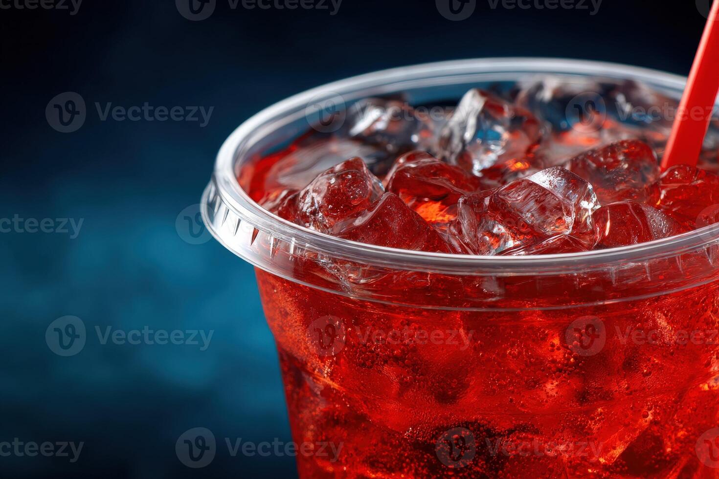 Refreshing red beverage with ice in a clear cup photo