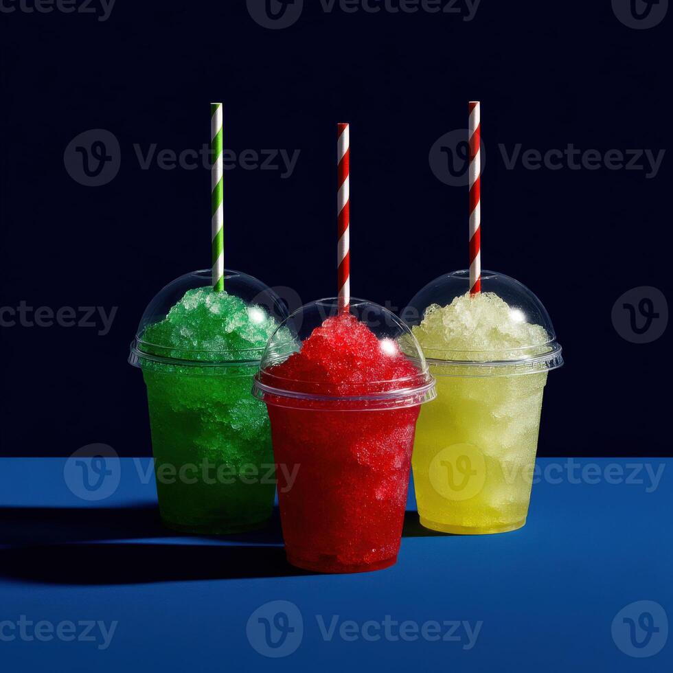 Colorful slush drinks in clear cups on a blue surface photo
