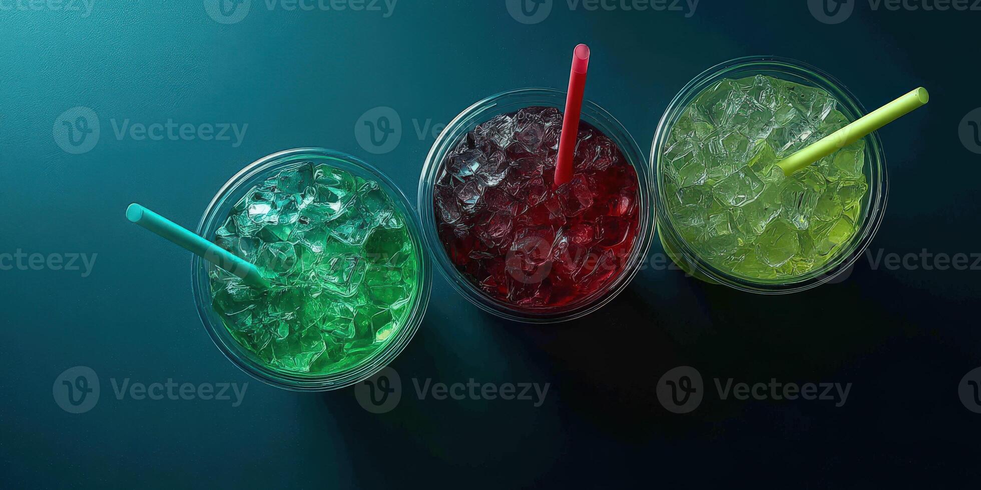 Refreshing colorful drinks with ice and straws on a table photo
