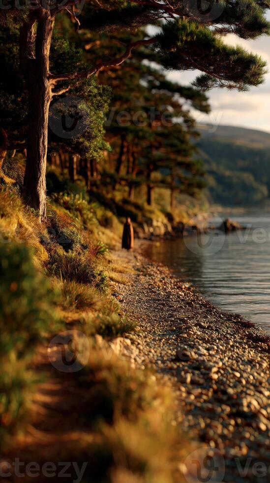 Viking woman walking along a tranquil lake shore during sunset photo