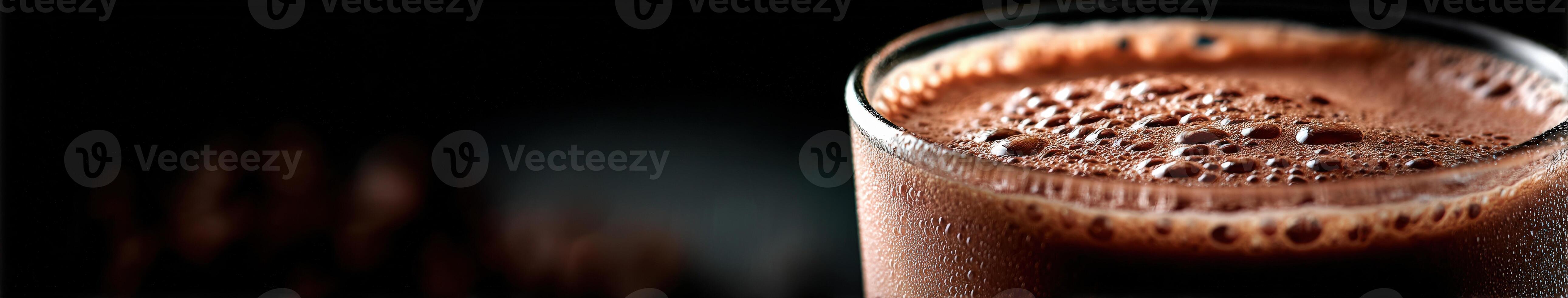 Delicious chocolate protein shake in glass against dark background photo