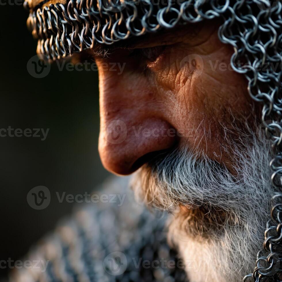 Elderly knight in chainmail reflecting on life's journey at dusk photo