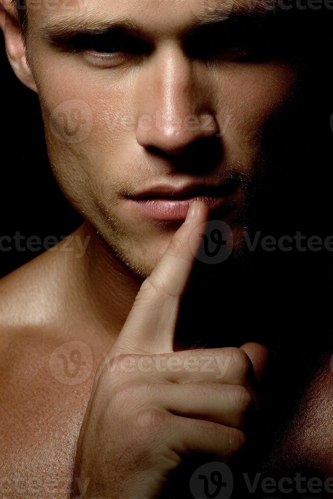 Silence conveys mystery in a close-up portrait of a man photo