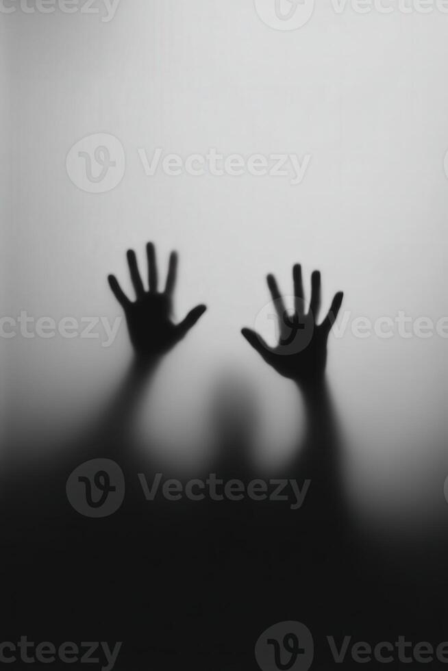Shadowy hands reaching out against a light background photo