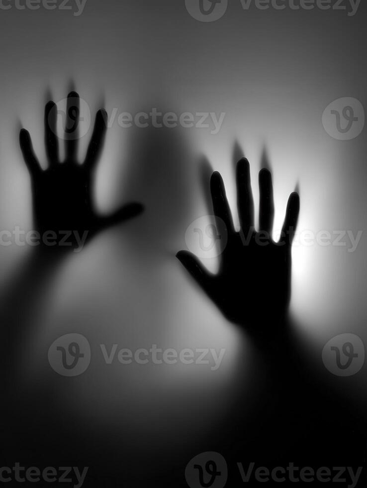 Shadows of desperation on a misty surface at night photo