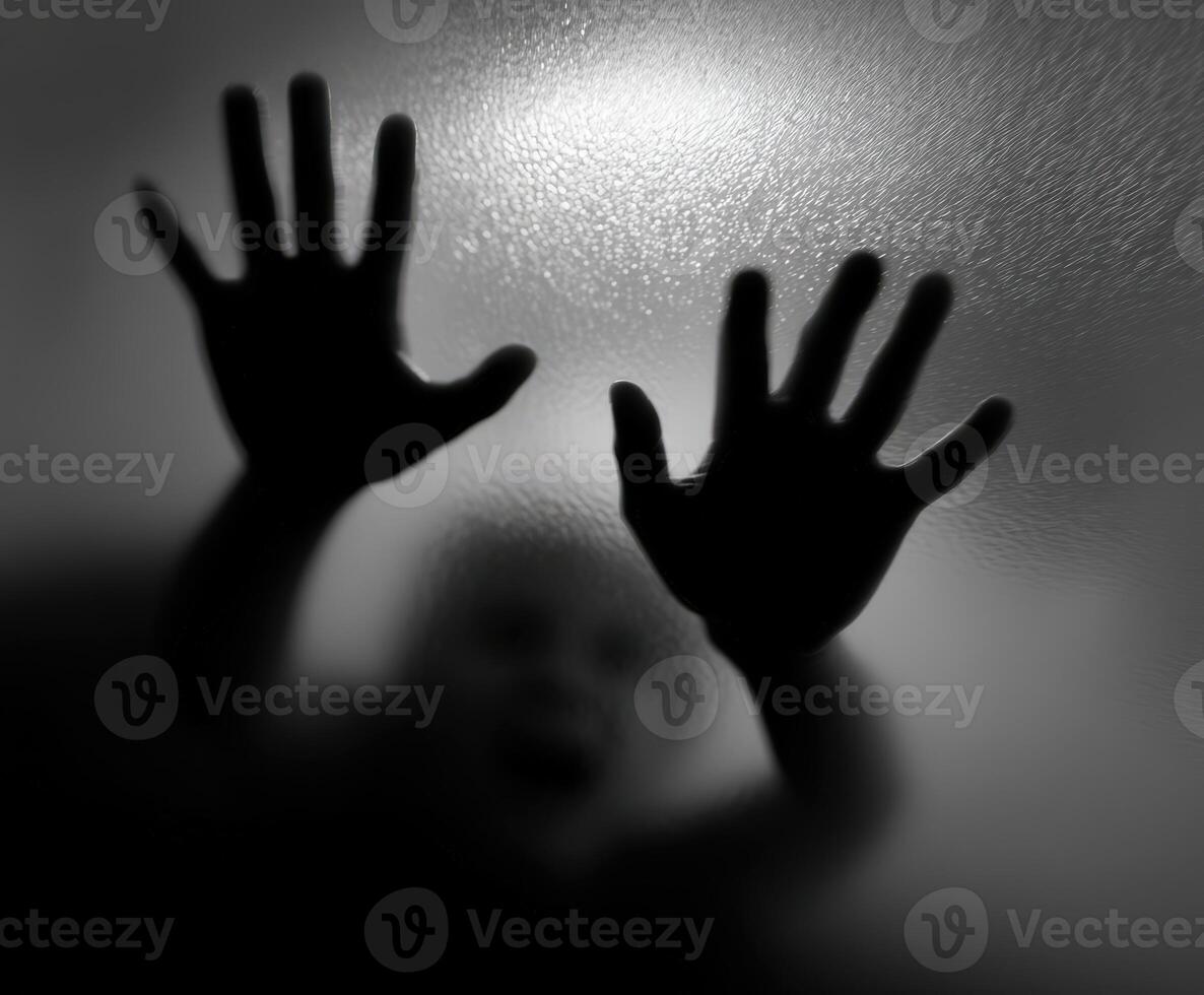 Child trapped behind a frosted glass door reaching out for help photo