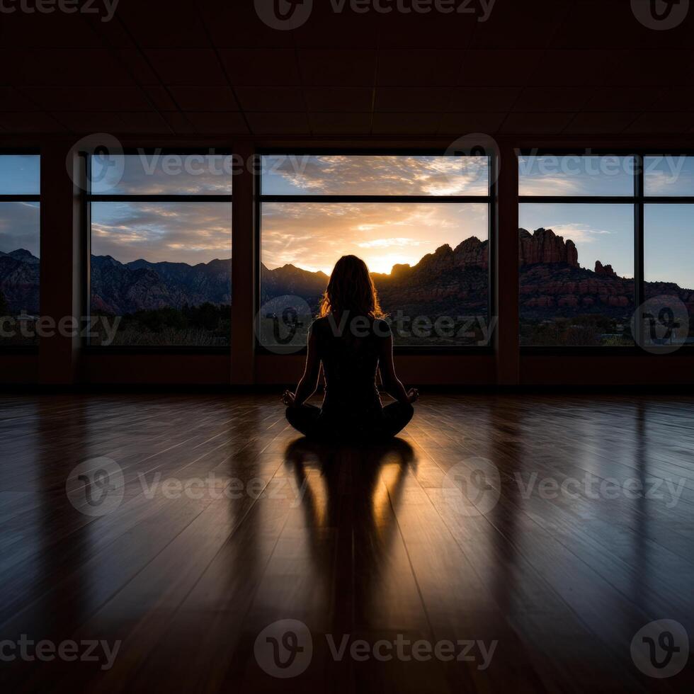Meditation session at sunset with mountain view in a serene studio photo