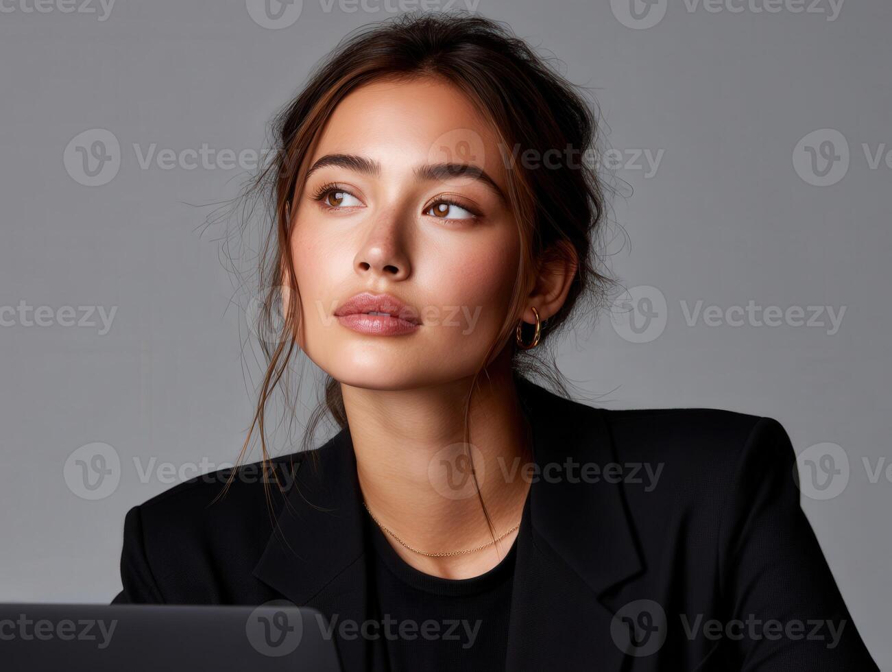Young woman with elegant style focuses on her work in a modern setting photo