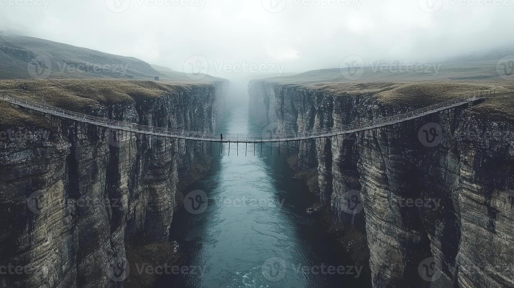 A bridge over a river in the middle of a canyon photo