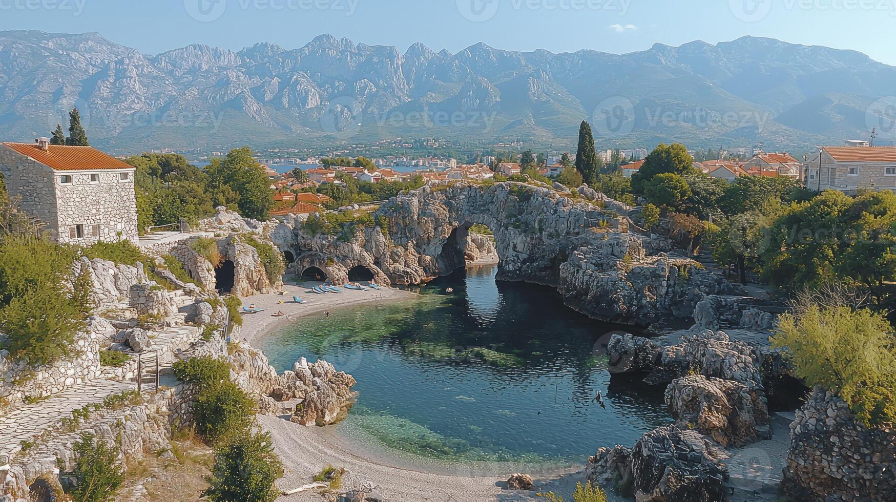 A view of a small town with a river and mountains photo